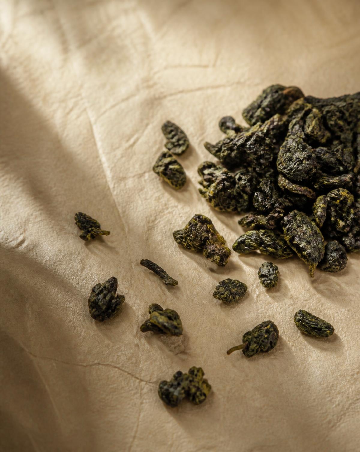 Loose leaf Chinese oolong on parchment